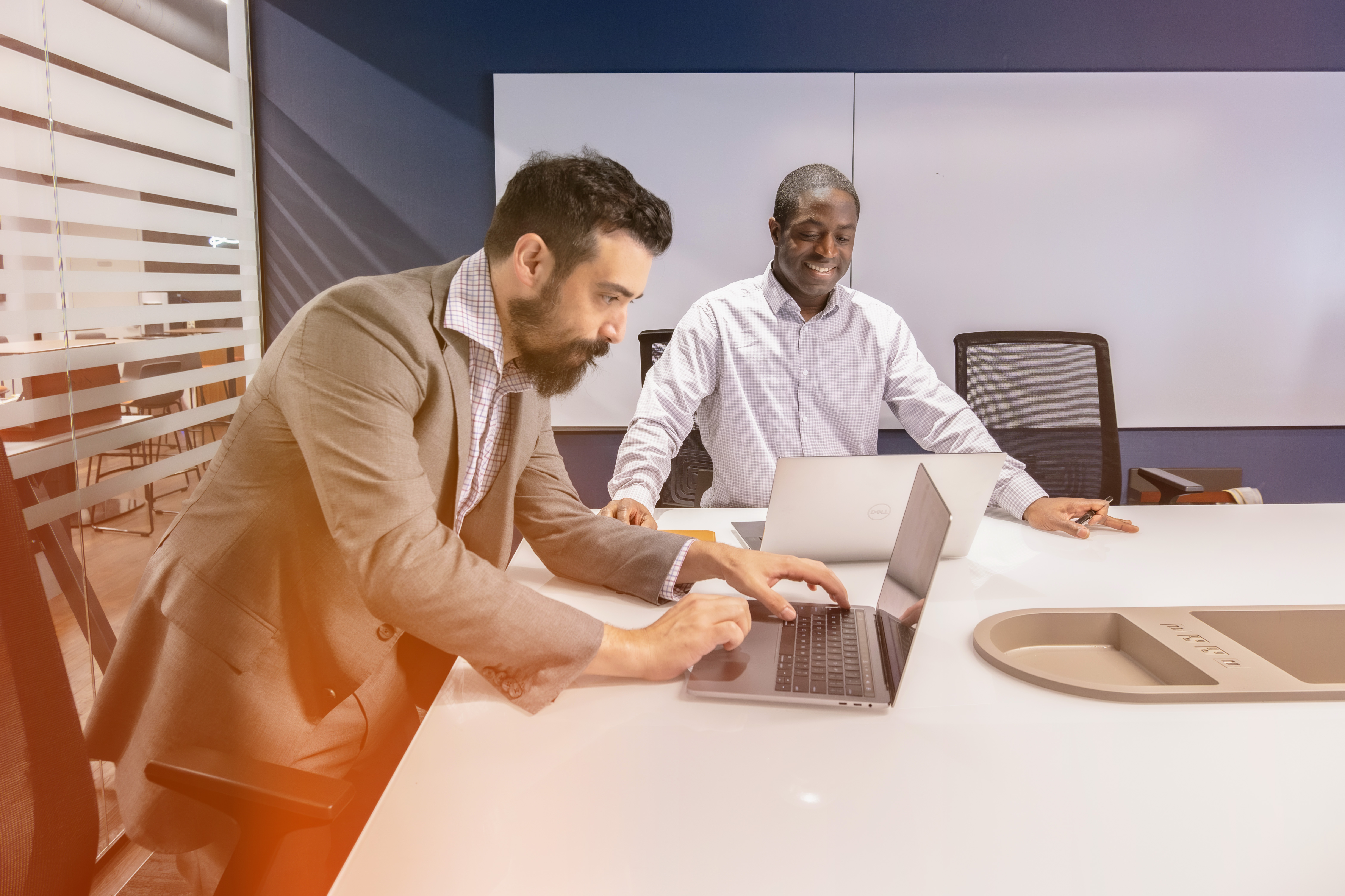 Two Men at a Table Working at Computers